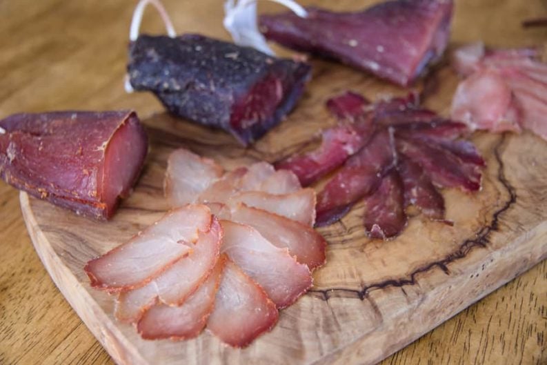 An assortment of sliced cured meats displayed on a charcuterie board.