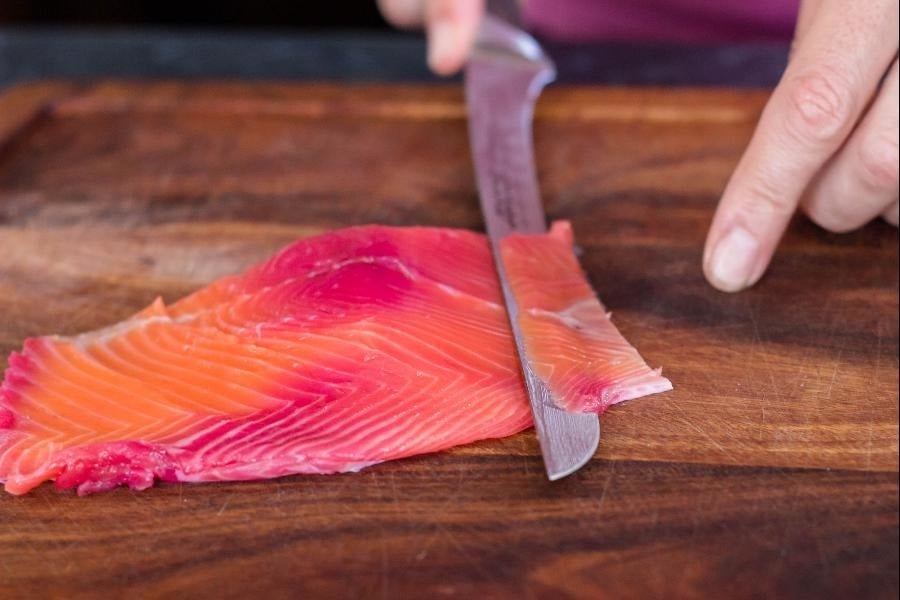 Slicing cured salmon gravlax large