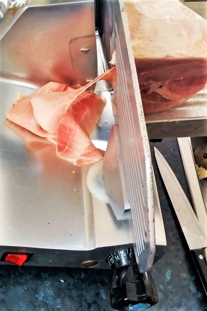 Slicing cured meat with deli meat slicer large 2