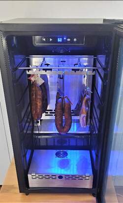 Cured meats aging gracefully in a SteakAger Pro 40, showcasing a delicious charcuterie in the making.
