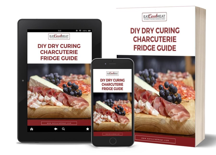 An array of digital devices displaying an ebook titled "diy dry curing charcuterie fridge guide" from "eat cure eat," showcasing instructions for making preserved meats at home.