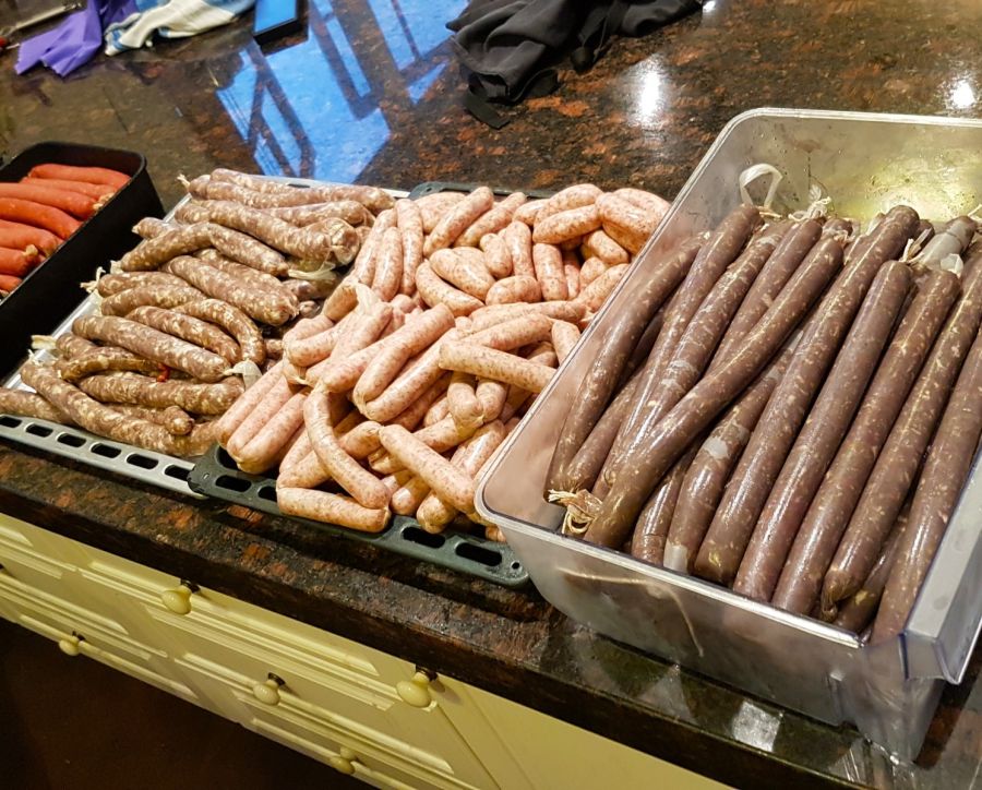 Left to Right Cooked/Smoked Hickory Hot Dogs, Raw Merguez Sausage, Raw Nurenberg Sausage, Slim Jim Smoked Venison Sausage - all using Sicilian fine sea salt
