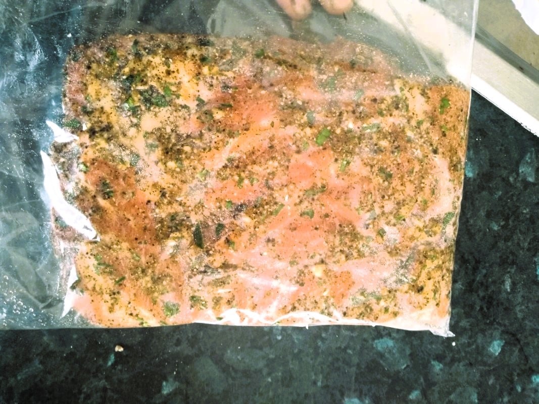 Meat which has a salt cure applied with spices inside a plastic bag.