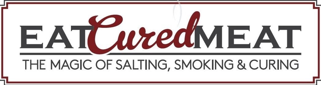 A logo featuring the brand name "Eat Cured Meat" in bold, with "Cured" elegantly written in cursive and red. Beneath, smaller text capitalizes on: "The Magic of Salting, Smoking & Curing." The logo is framed by a thin rectangular border.